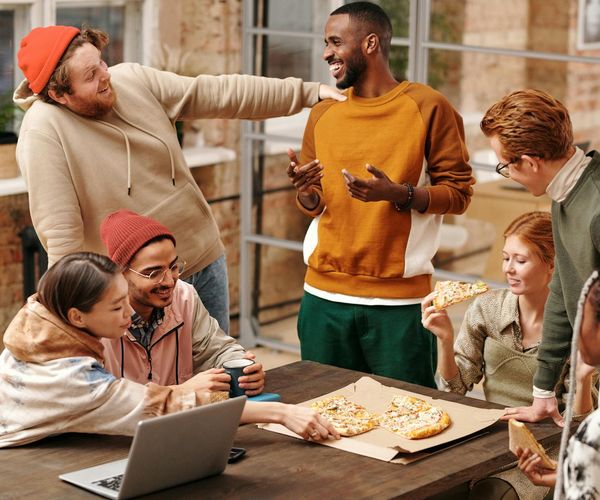 Happy group of people talking and laughing after a workout session.