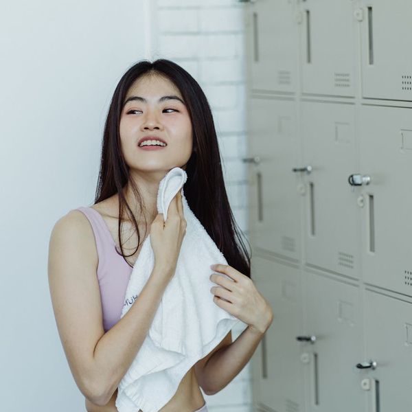 Smiling woman feeling refreshed and energetic after a workout.